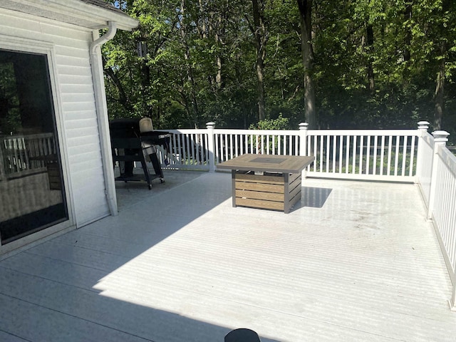 wooden terrace featuring a grill