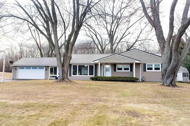 ranch-style home with metal roof, an attached garage, and a front yard