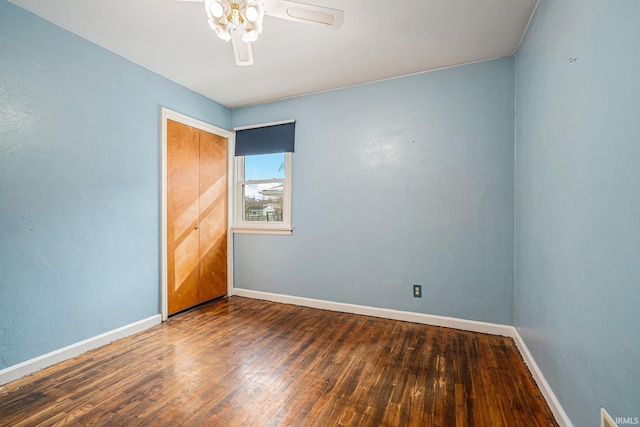 unfurnished room with baseboards, ceiling fan, and hardwood / wood-style floors