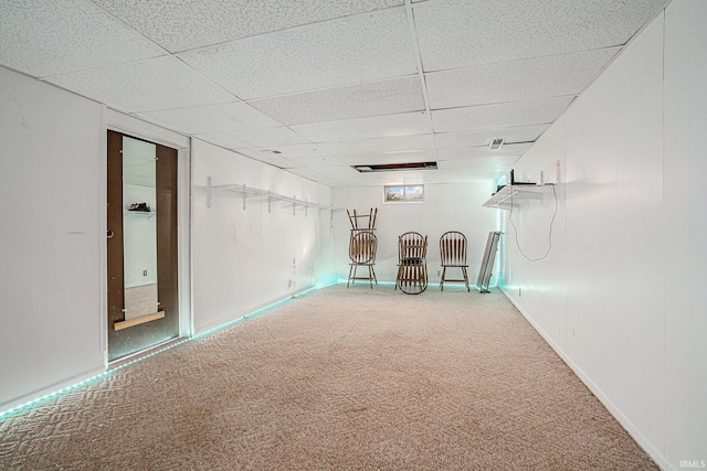 spare room featuring a paneled ceiling and carpet flooring