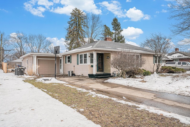 ranch-style house with driveway and an attached garage