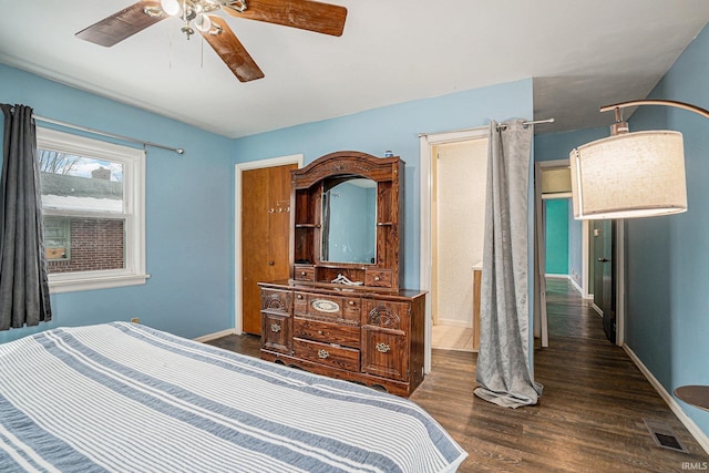 bedroom with ceiling fan, wood finished floors, visible vents, and baseboards