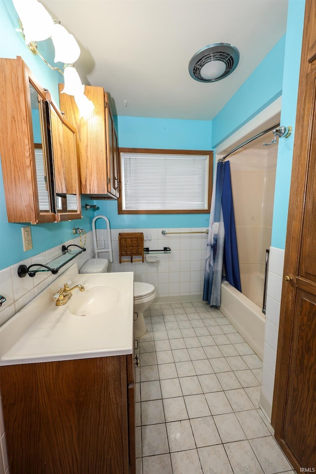 full bath featuring tile patterned flooring, toilet, vanity, tile walls, and shower / bathtub combination with curtain