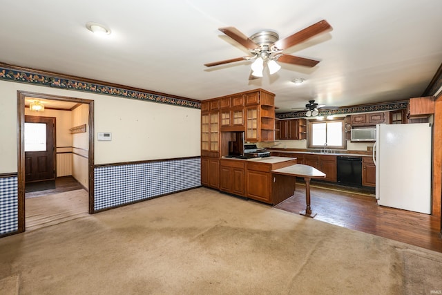 kitchen featuring a wainscoted wall, carpet floors, black dishwasher, freestanding refrigerator, and open shelves