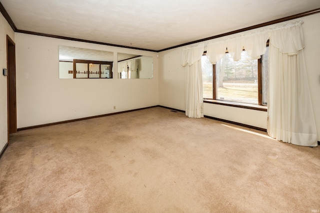 spare room with carpet, ornamental molding, and baseboards