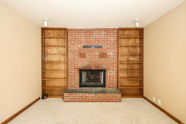 unfurnished living room with a brick fireplace, carpet, and baseboards