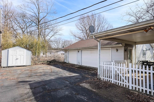 exterior space featuring a storage shed and fence