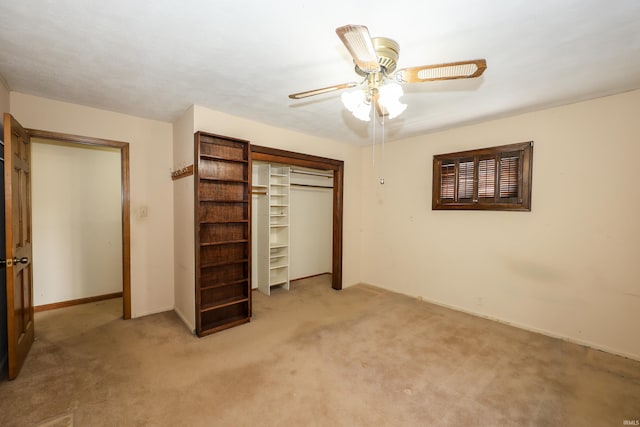 unfurnished bedroom featuring baseboards, a closet, a ceiling fan, and carpet flooring