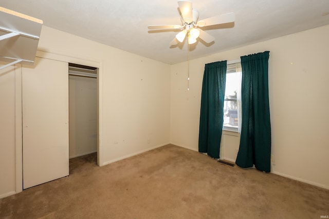 unfurnished bedroom with ceiling fan, a closet, carpet, and visible vents