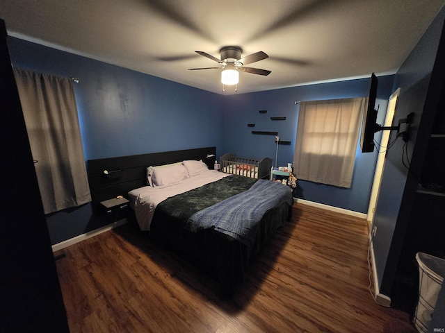 bedroom featuring wood finished floors, a ceiling fan, and baseboards