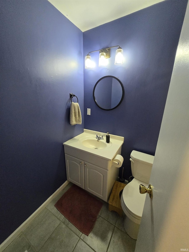 bathroom with vanity, tile patterned flooring, toilet, and baseboards