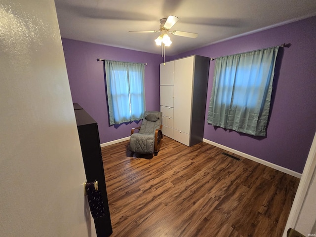 unfurnished bedroom featuring a ceiling fan, wood finished floors, visible vents, and baseboards