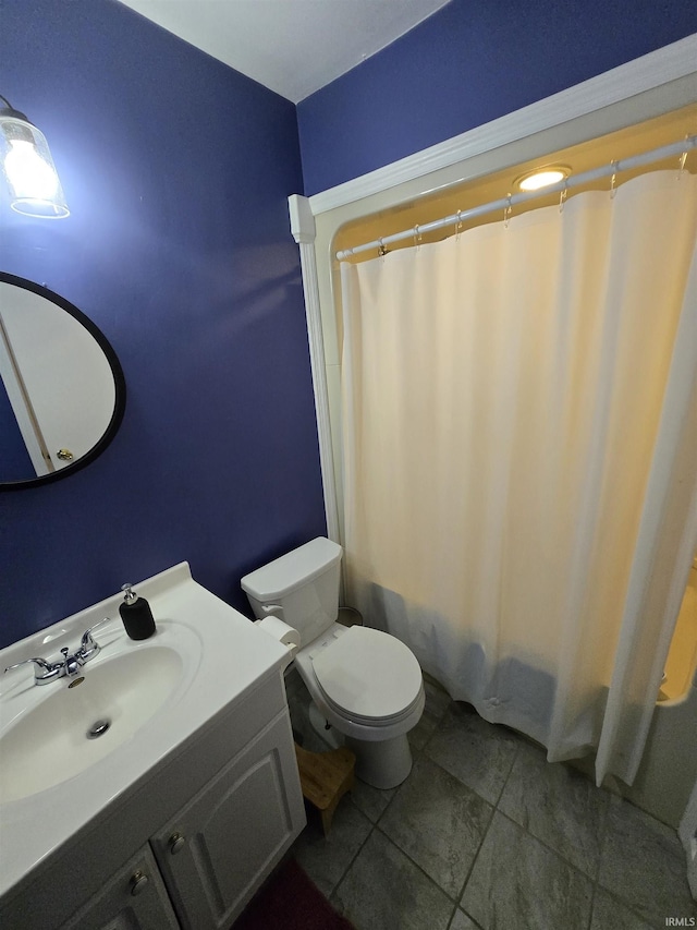 full bathroom featuring shower / bath combination with curtain, vanity, and toilet