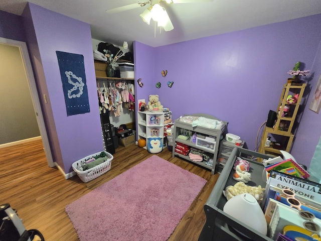 bedroom featuring baseboards, a closet, a ceiling fan, and wood finished floors