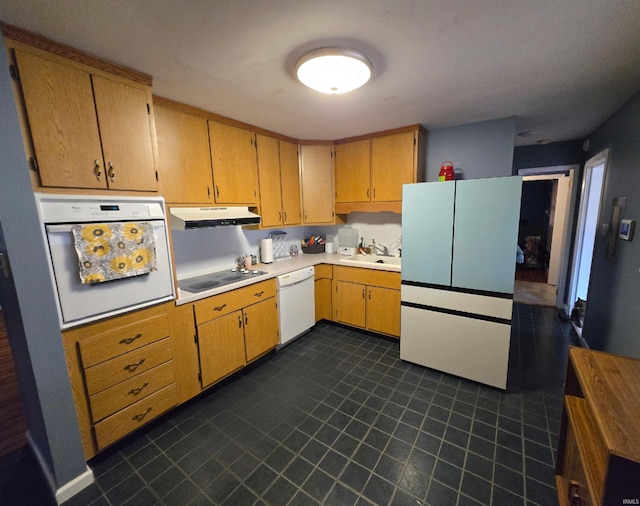 kitchen with light countertops, white appliances, a sink, and under cabinet range hood