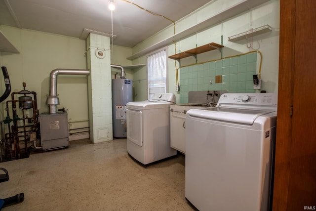 laundry room featuring washer and dryer, gas water heater, a heating unit, and laundry area