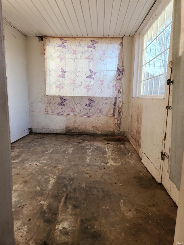 spare room featuring unfinished concrete flooring