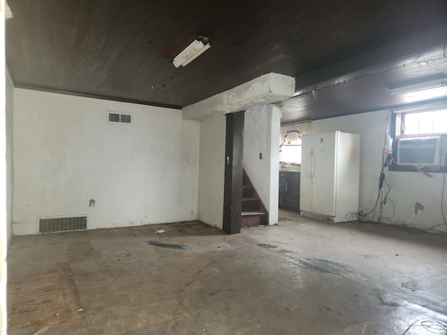 basement with stairway, visible vents, and cooling unit