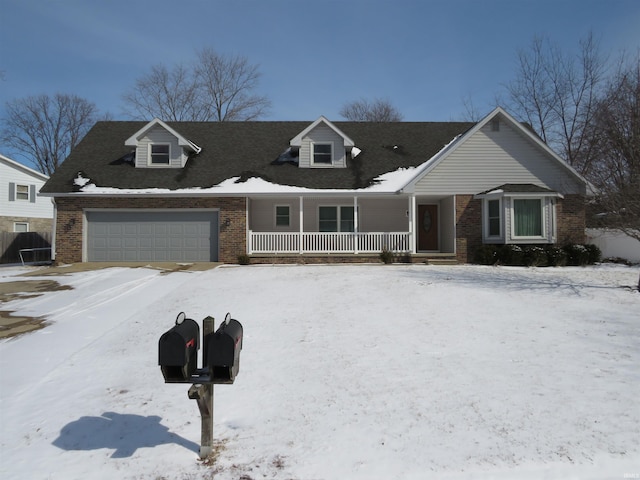 new england style home with covered porch, brick siding, and an attached garage