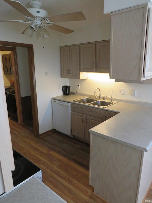 kitchen featuring a peninsula, white appliances, a sink, light countertops, and dark wood-style floors