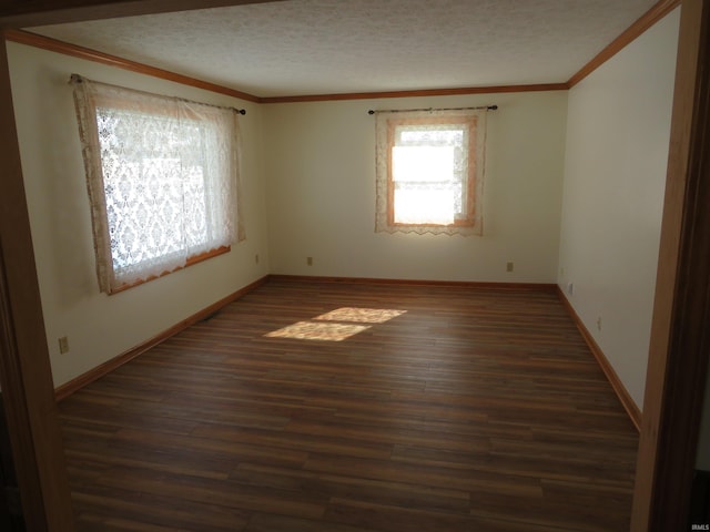 unfurnished room with crown molding, a textured ceiling, baseboards, and wood finished floors