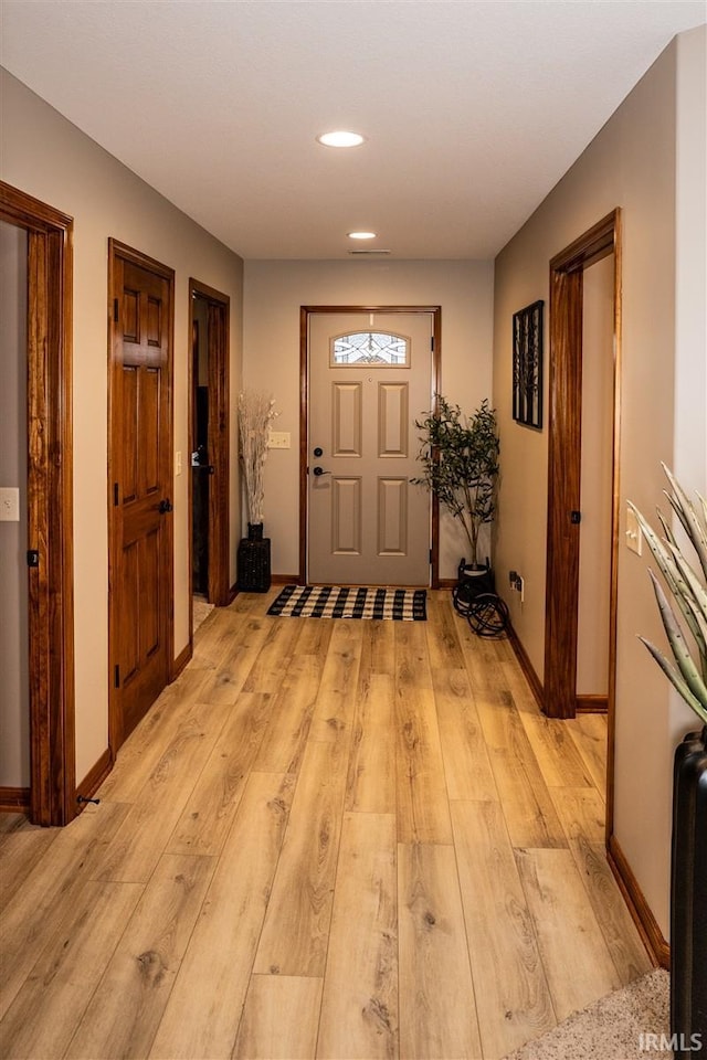 interior space with light wood-type flooring, baseboards, and recessed lighting