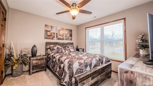 bedroom with light carpet, baseboards, visible vents, and ceiling fan