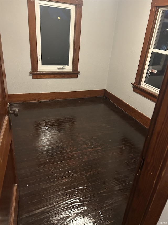 interior space featuring baseboards and wood finished floors