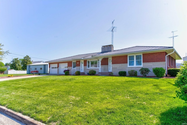 ranch-style home with brick siding, a chimney, a front yard, metal roof, and a garage