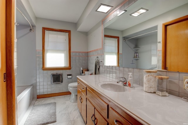 bathroom featuring marble finish floor, plenty of natural light, vanity, and toilet