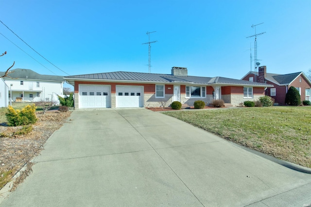 ranch-style house featuring a chimney, metal roof, an attached garage, a standing seam roof, and a front lawn