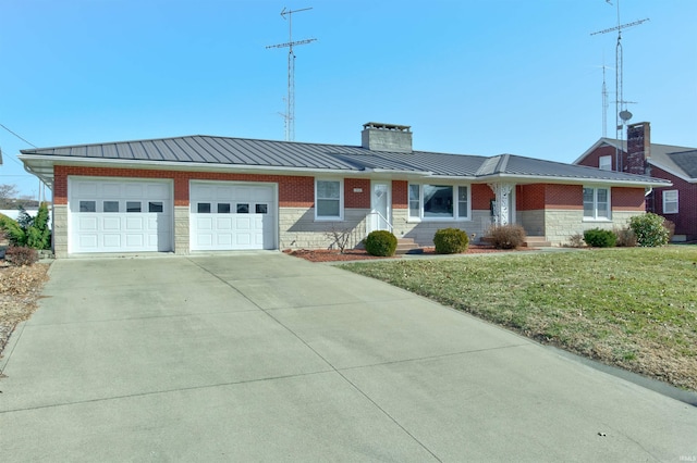 ranch-style house with concrete driveway, a chimney, metal roof, an attached garage, and a standing seam roof