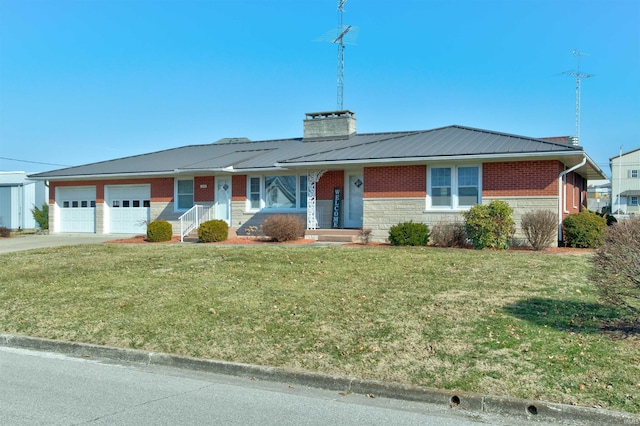 single story home with an attached garage, a chimney, metal roof, and brick siding