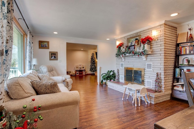 living area with wood finished floors and crown molding