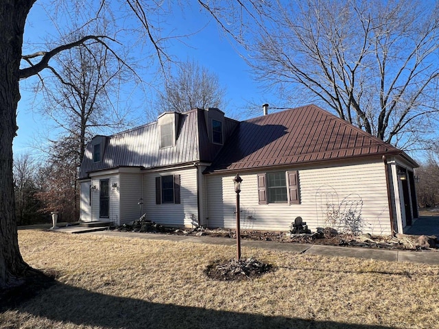 view of side of home featuring metal roof