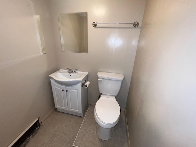 bathroom featuring tile patterned flooring, baseboards, vanity, and toilet