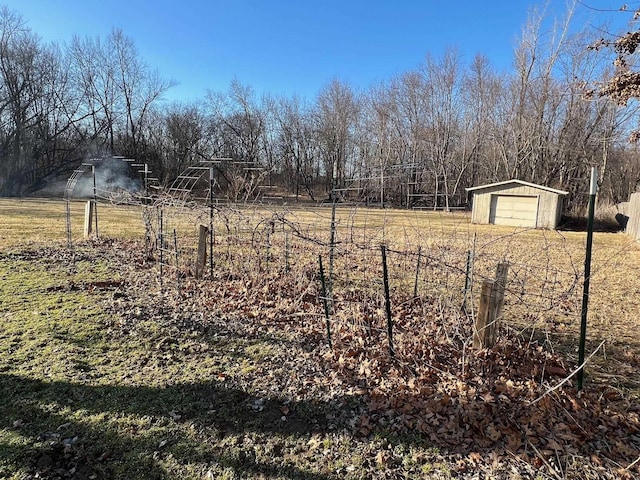 view of yard with an outbuilding, fence, and a detached garage