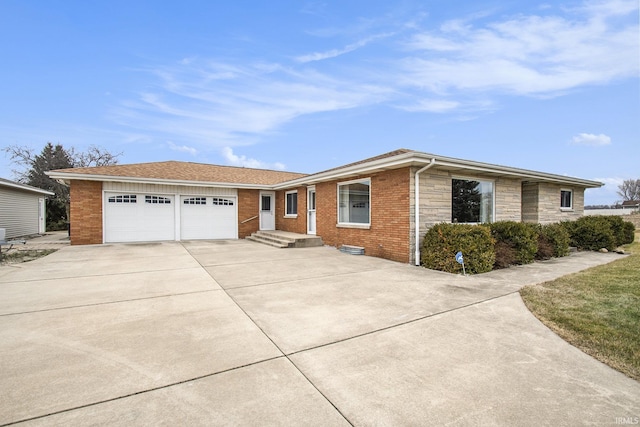 ranch-style home with stone siding, concrete driveway, brick siding, and an attached garage