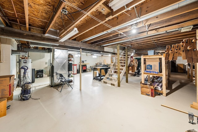 unfinished basement with water heater and gas water heater