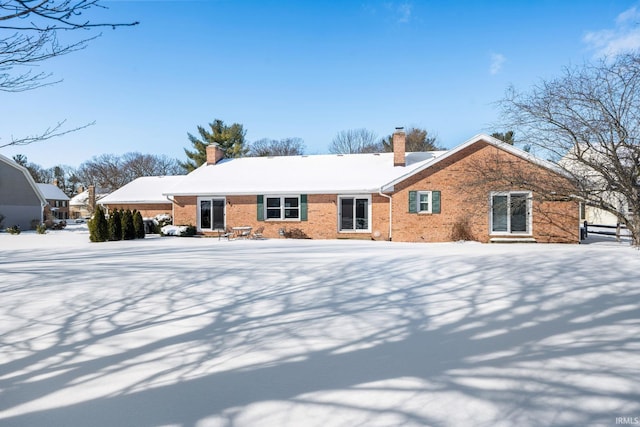 exterior space with brick siding and a chimney