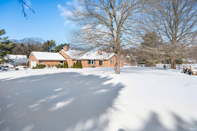 view of front of home with brick siding and a chimney