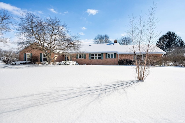 single story home featuring brick siding