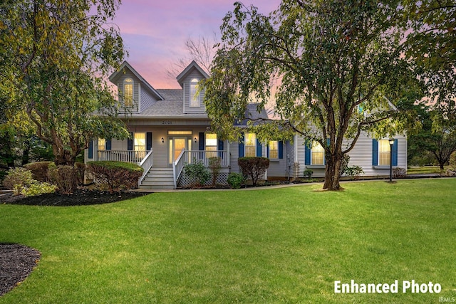 cape cod-style house featuring a porch and a front lawn