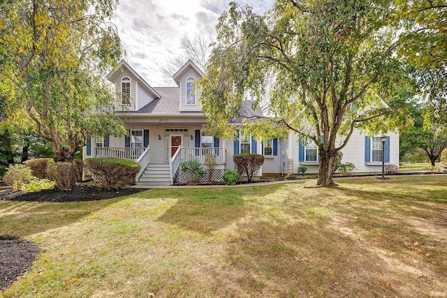 cape cod-style house featuring covered porch and a front yard