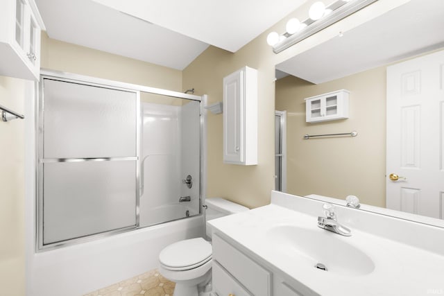 full bathroom featuring toilet, bath / shower combo with glass door, and vanity