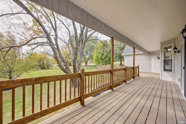 wooden terrace with a yard