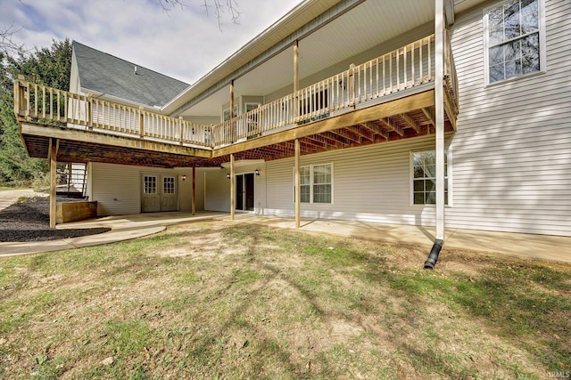 rear view of property featuring a deck and a patio