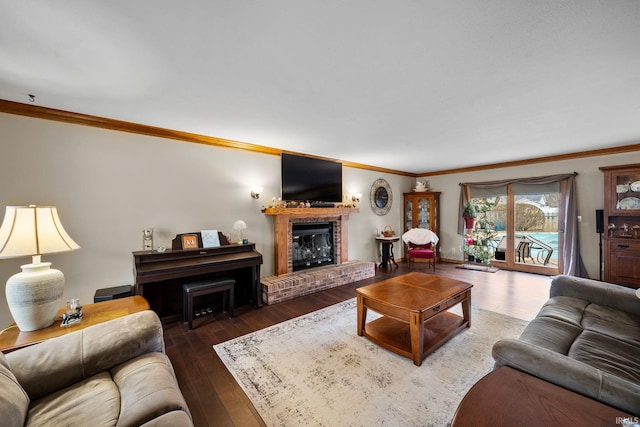 living room with wood-type flooring, a fireplace, and ornamental molding