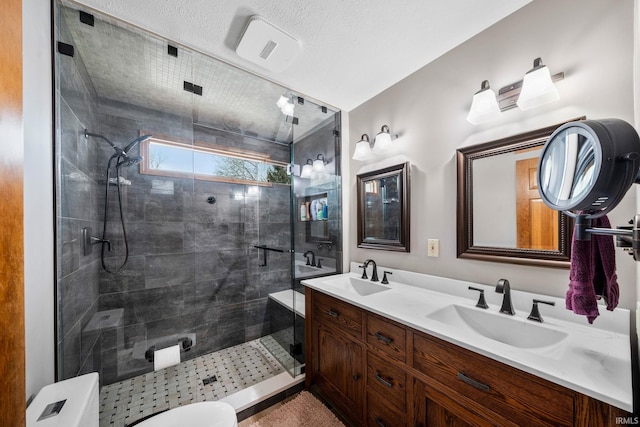 full bathroom featuring double vanity, a shower stall, and a sink