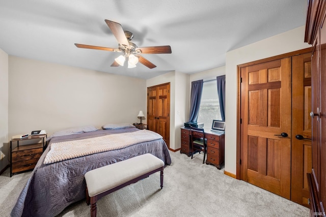 bedroom featuring light carpet, ceiling fan, and baseboards